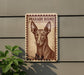 a sign with a picture of a dog, specifically a pharaoh hound, mounted on a wall.