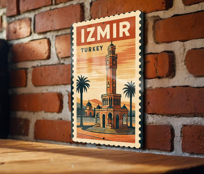 A vintage-style poster of the Izmir Tower, a famous landmark in Turkey, is displayed on a brick wall.