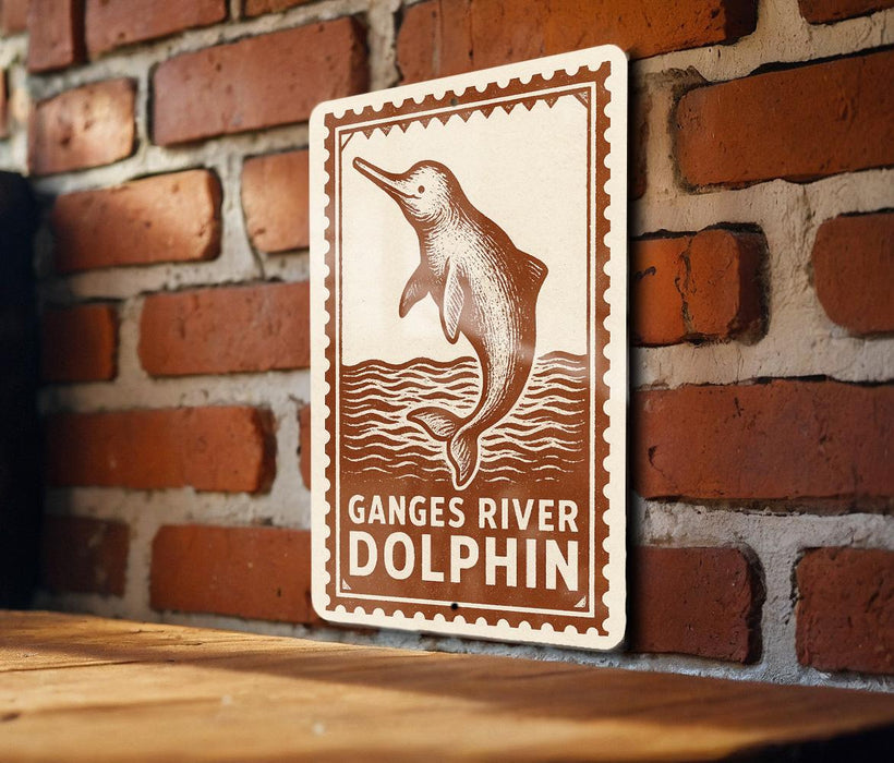 a sign with a dolphin illustration and the text "Ganges River Dolphin" on a brick wall.