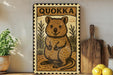 a framed illustration of a quokka, a small marsupial, on a shelf.