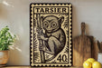 a decorative metal sign with a monkey illustration, placed on a shelf next to a wooden cutting board and some lemons.