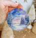 a person holding a christmas ornament in their hand