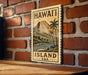 A wooden sign with a tropical island landscape and palm trees is mounted on a brick wall.