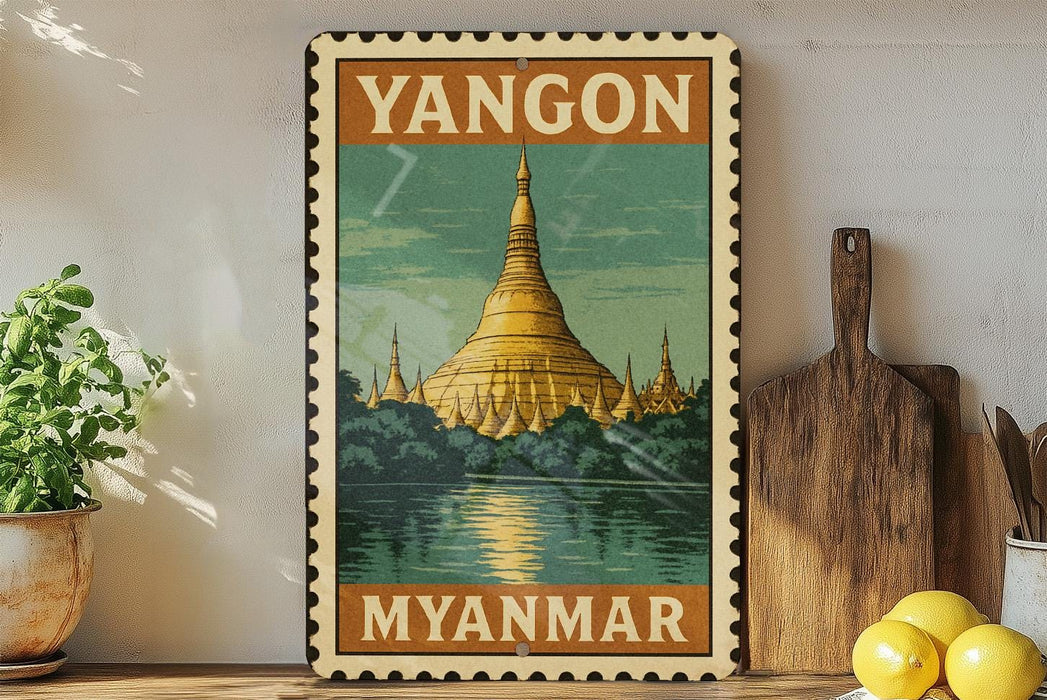 A vintage-style poster of the Shwedagon Pagoda, a famous Buddhist temple in Yangon, Myanmar, is displayed on a wall.