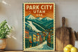 A vintage-style metal sign with a colorful illustration of a town in Park City, Utah, USA, featuring mountains in the background.