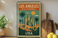 A vintage-style metal sign with a colorful illustration of Los Angeles, California, featuring palm trees, skyscrapers, and a sunset. The sign is framed with a border and displays the text "LOS ANGELES, CALIFORNIA USA".