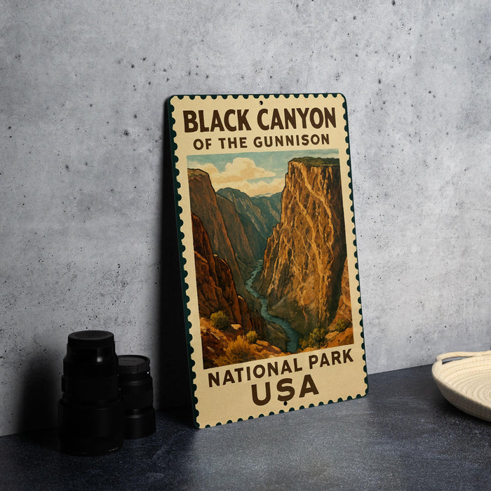 A vintage-style metal sign for the Black Canyon of the Gunnison National Park, featuring a painting of the canyon landscape.
