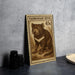 A wooden postcard featuring a Tasmanian Devil, a type of small marsupial, is displayed on a table.