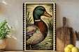 a framed illustration of a duck, which is displayed on a shelf next to a wooden cutting board and some lemons.