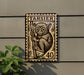 a large, detailed stamp-like artwork of a tarsier, a primate native to Madagascar, mounted on a wall.
