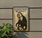 a monkey sitting on a branch, with a stamp-like border around it.