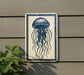 a blue and white sign depicting a jellyfish with long tentacles, mounted on a wall next to a plant.