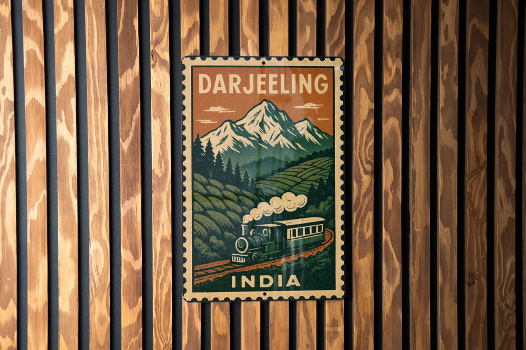 A vintage-style poster of a train traveling through a mountainous landscape, with the text "DARJEELING" and "INDIA" prominently displayed.