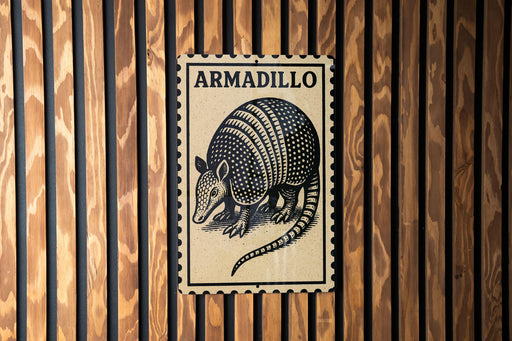 A metal sign with the word "ARMADILLO" printed on it, featuring an illustration of an armadillo.