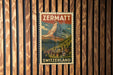 A vintage-style poster of the Matterhorn mountain in Switzerland, featuring a colorful illustration of the mountain and a small village in the foreground.