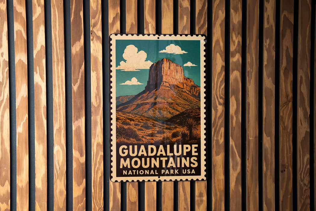A vintage postage stamp featuring a mountain landscape with the text "GUADALUPE MOUNTAINS NATIONAL PARK USA" prominently displayed.