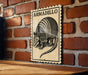 A sign featuring an illustration of an armadillo is mounted on a brick wall.