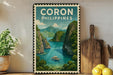 A framed poster of a tropical island landscape with a boat in the water, surrounded by lush greenery and mountains, is displayed on a wall next to a wooden cutting board and a potted plant.