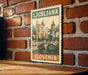 A vintage-style postage stamp depicting the city of Ljubljana, Slovenia, hanging on a brick wall.