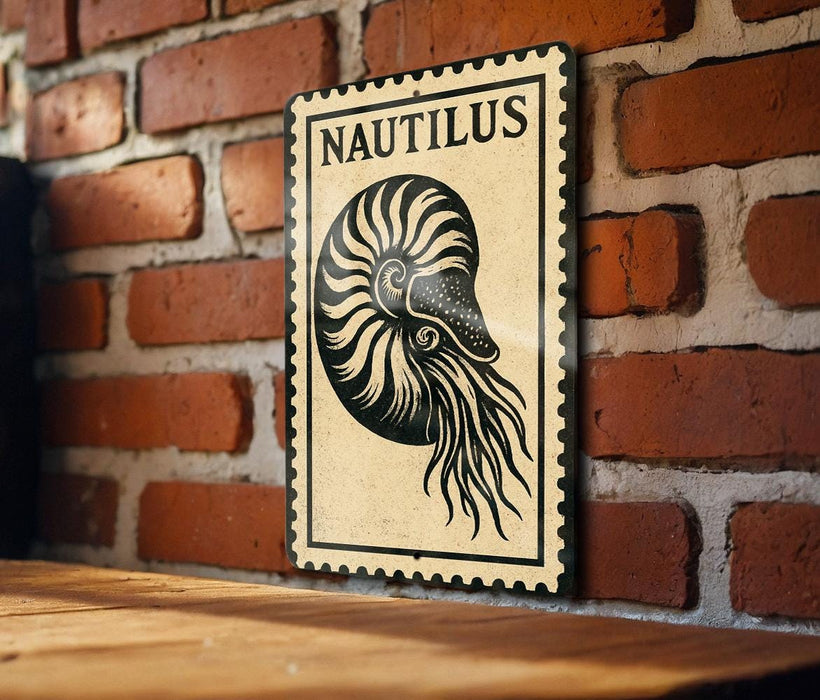 A metal sign with a nautilus shell design is mounted on a brick wall.