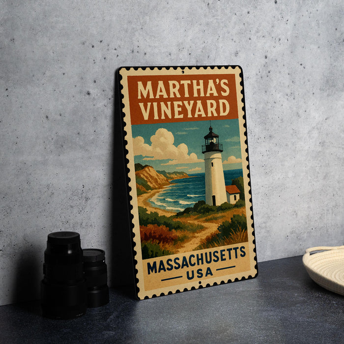 A vintage-style metal sign with a lighthouse and coastal landscape, featuring the text "MARTHA'S VINEYARD" and "MASSACHUSETTS USA".