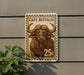 A 25c postage stamp featuring a buffalo illustration is mounted on a wall.