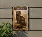 A postage stamp featuring a brown mink sitting on the ground, with the number 20 visible below the image.