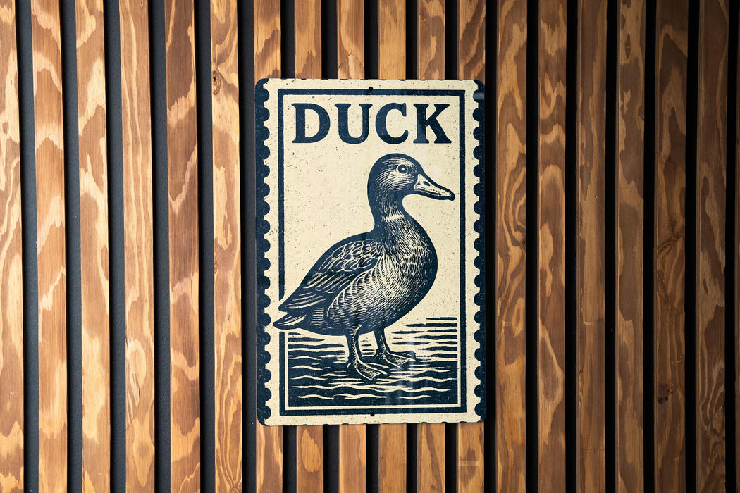A metal sign with the word "DUCK" on it is mounted on a wooden wall.