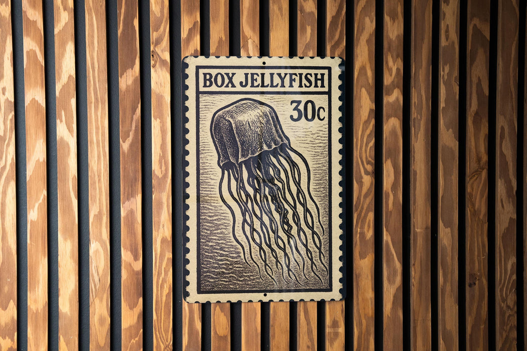 A vintage-style postage stamp featuring a jellyfish, with the text "BOX JELLYFISH 30c" printed on it.
