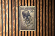 A vintage-style postage stamp featuring a jellyfish, with the text "BOX JELLYFISH 30c" printed on it.