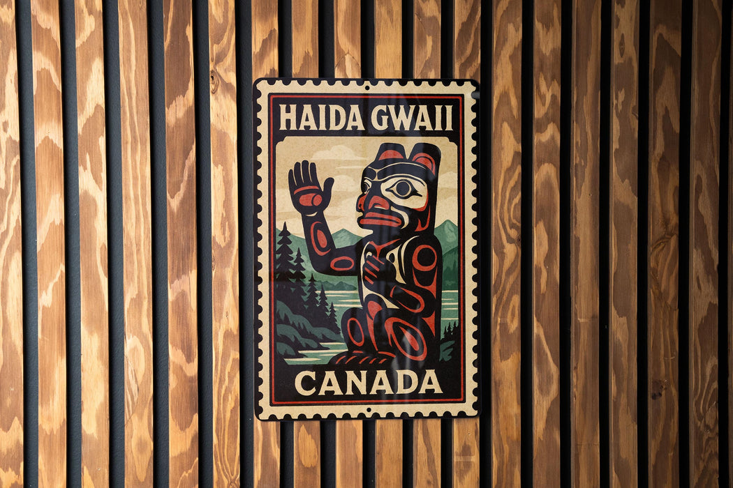 A metal sign with a stylized illustration of a bear and the text "HAIDA GWALL CANADA" is displayed on a wooden wall.