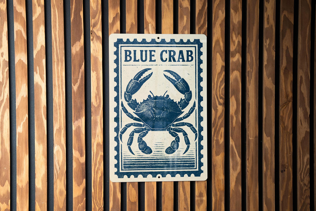 A blue crab sign is displayed on a wooden wall.