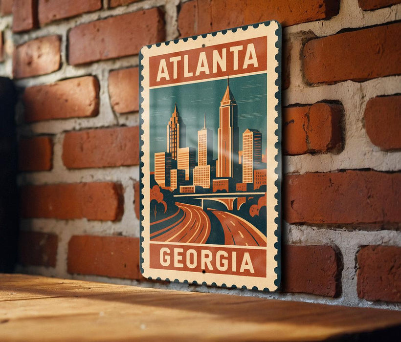 A vintage-style metal sign with the text "ATLANTA GEORGIA" displayed on a brick wall.