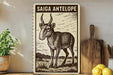 a wooden sign with a drawing of a goat or antelope, placed on a shelf next to a wooden cutting board and some lemons.