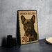 A French Bulldog stamp is displayed on a table, with a stack of black camera lenses and a white dish nearby.