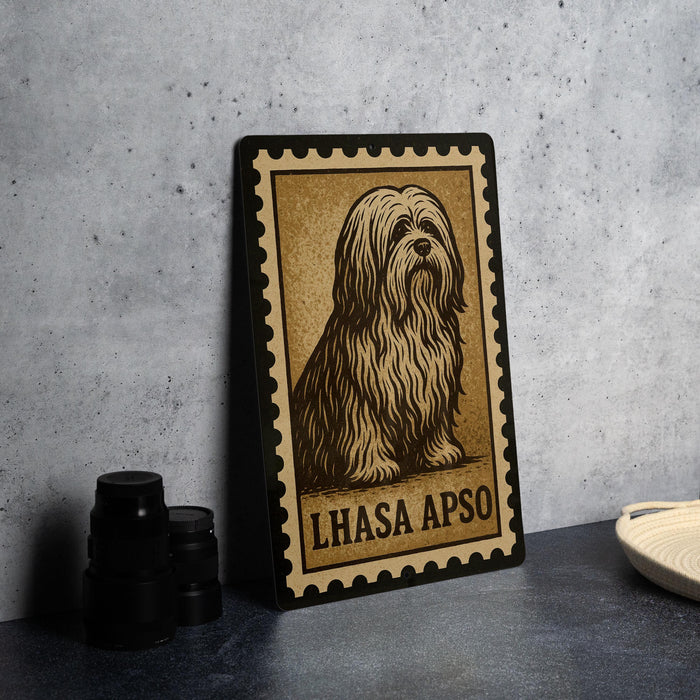 A framed illustration of a long-haired dog, likely a Lhasa Apso, is displayed on a wall next to a stack of black camera lenses.