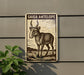 a sign with a drawing of a goat or antelope, mounted on a wall.