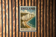 A vintage-style postage stamp depicting the White Cliffs of Dover, a famous landmark in England.