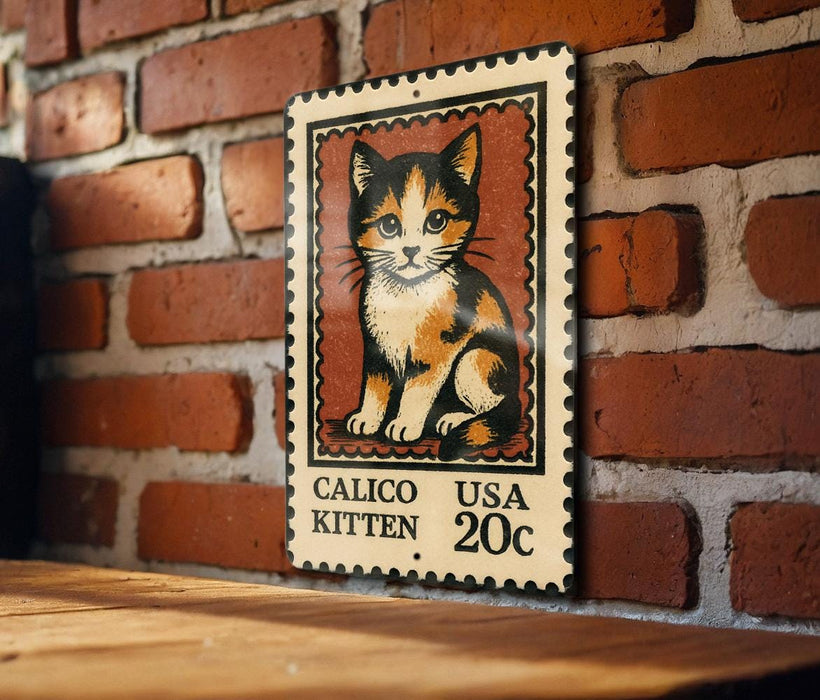 A metal sign featuring a calico kitten on a brick wall.