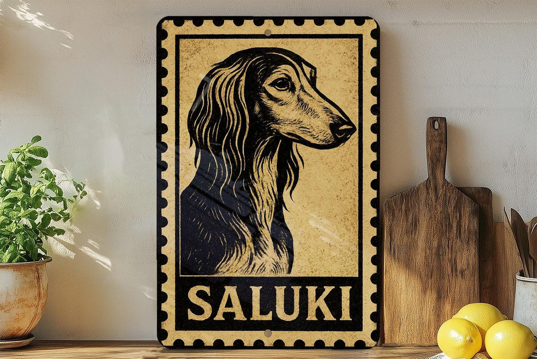 a framed illustration of a Saluki dog, with the word "SALUKI" written below it. The framed picture is displayed on a shelf next to a wooden cutting board and a potted plant.