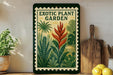 a framed poster of a tropical plant garden, with a wooden cutting board and a potted plant to the left.