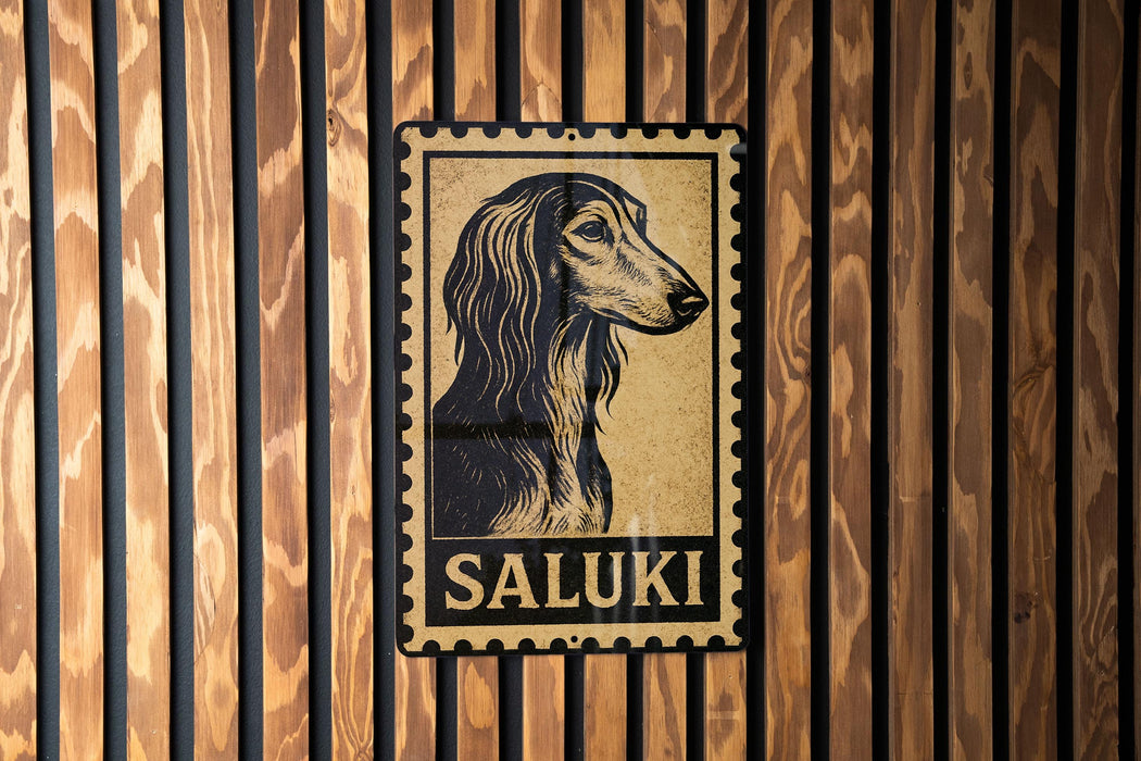 A metal sign with a stylized image of a dog's head and the word "SALUKI" printed on it, mounted on a wooden wall.