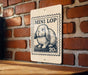 A sign featuring a rabbit on a brick wall, with a 20 cent stamp-like design.