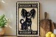 A vintage-style metal sign with a black and white illustration of a Russian toy dog, placed on a wooden surface next to a wooden cutting board and some lemons.