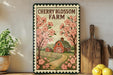 A framed illustration of a cherry blossom farm with a red barn, surrounded by pink flowers and a dirt road, is displayed on a shelf next to a wooden cutting board and a potted plant.