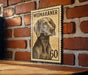 A weimaran stamp with the number 60 on it, mounted on a brick wall.