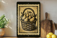 a framed illustration of a basket filled with pears, placed on a shelf next to a wooden cutting board and a potted plant.