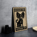 A metal sign with a black and white illustration of a Russian toy dog, sitting on a table.