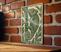 a metal sign with a chameleon illustration on it, mounted on a brick wall.
