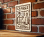 A sign with the text "CANDLE MAKING" is displayed on a brick wall, with various candle-making tools and a lit candle visible in the image.